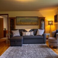 Living room with two large picture windows comfortably seats 7.