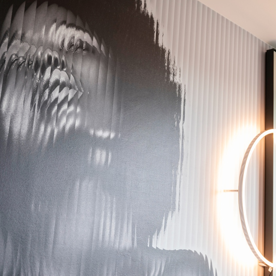 Artwork on the wall: a black and white picture of a woman