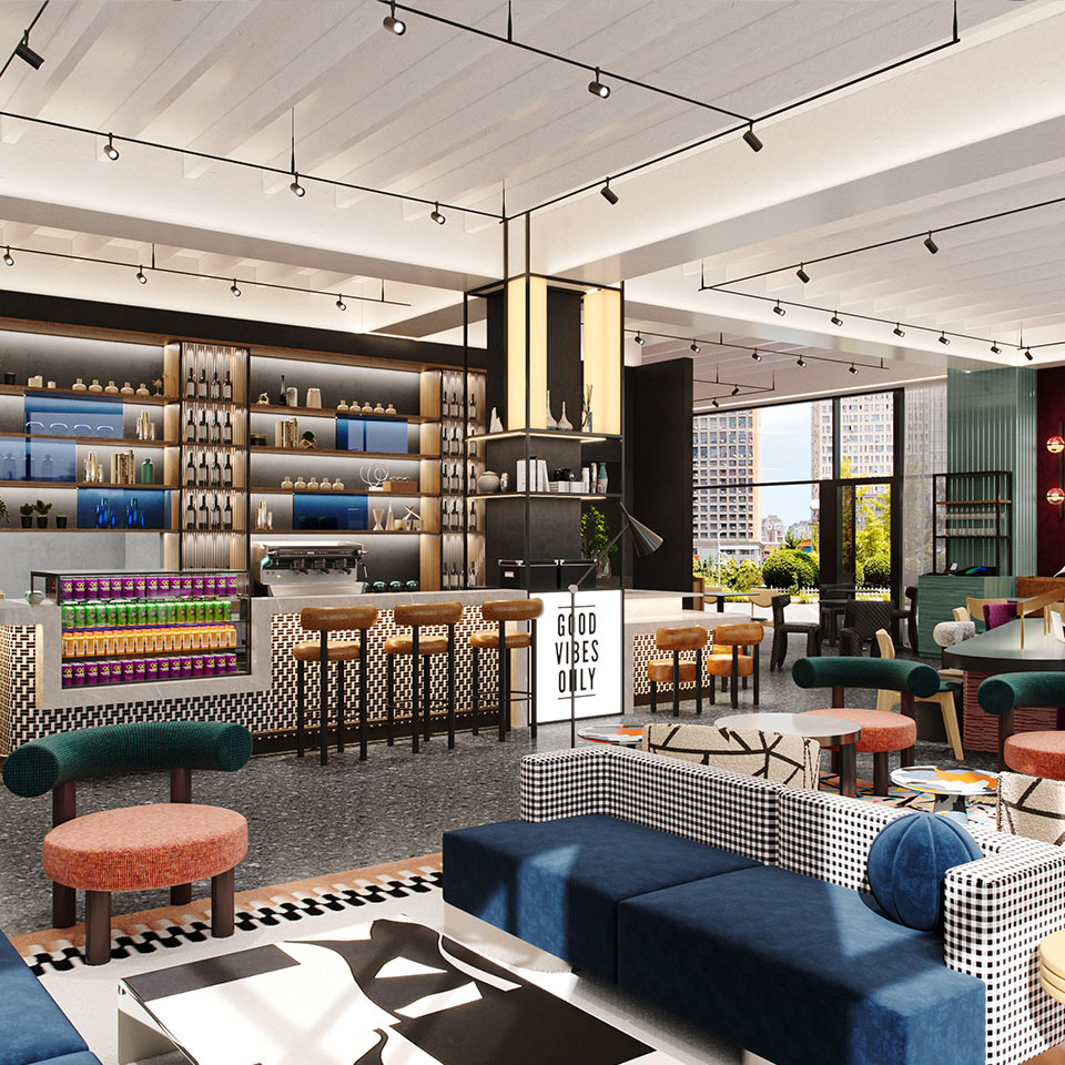 Modern hotel interior with a stylish, open design. Features a bar with stools, shelves of decor, and a sign saying "Good Vibes Only." Bright and inviting atmosphere.