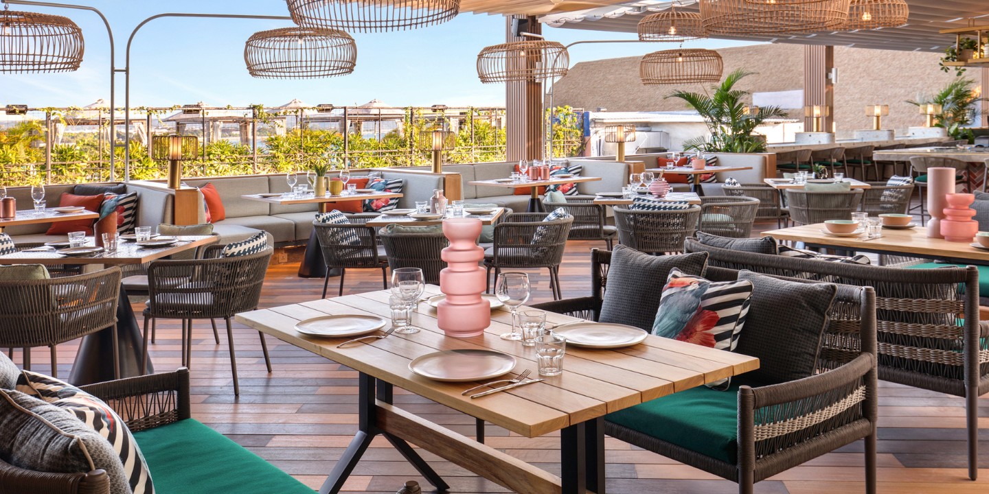 the outdoor terrace at Afterglow Restaurant with several laid tables and seating ares