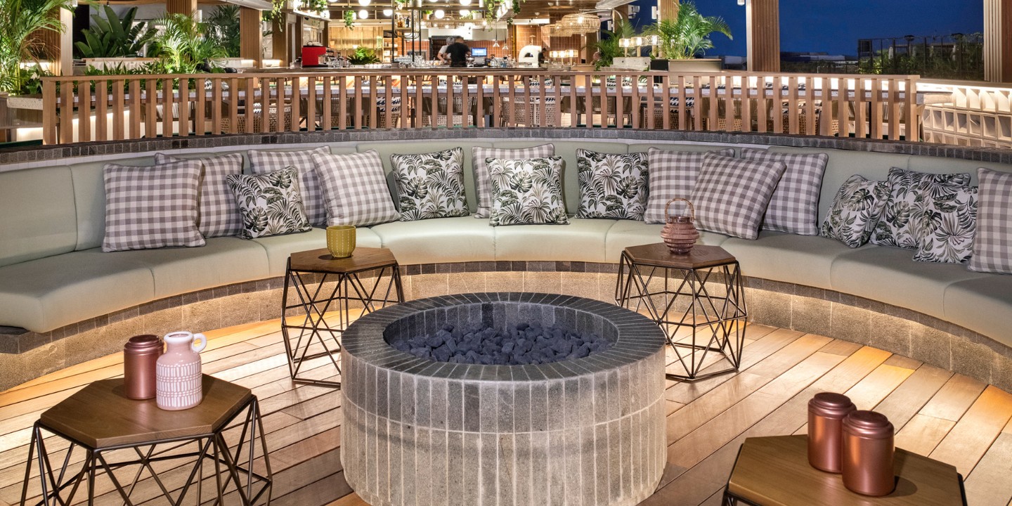 The outdoor lounge area around a firepit at TRIBE Bali Kuta Beach