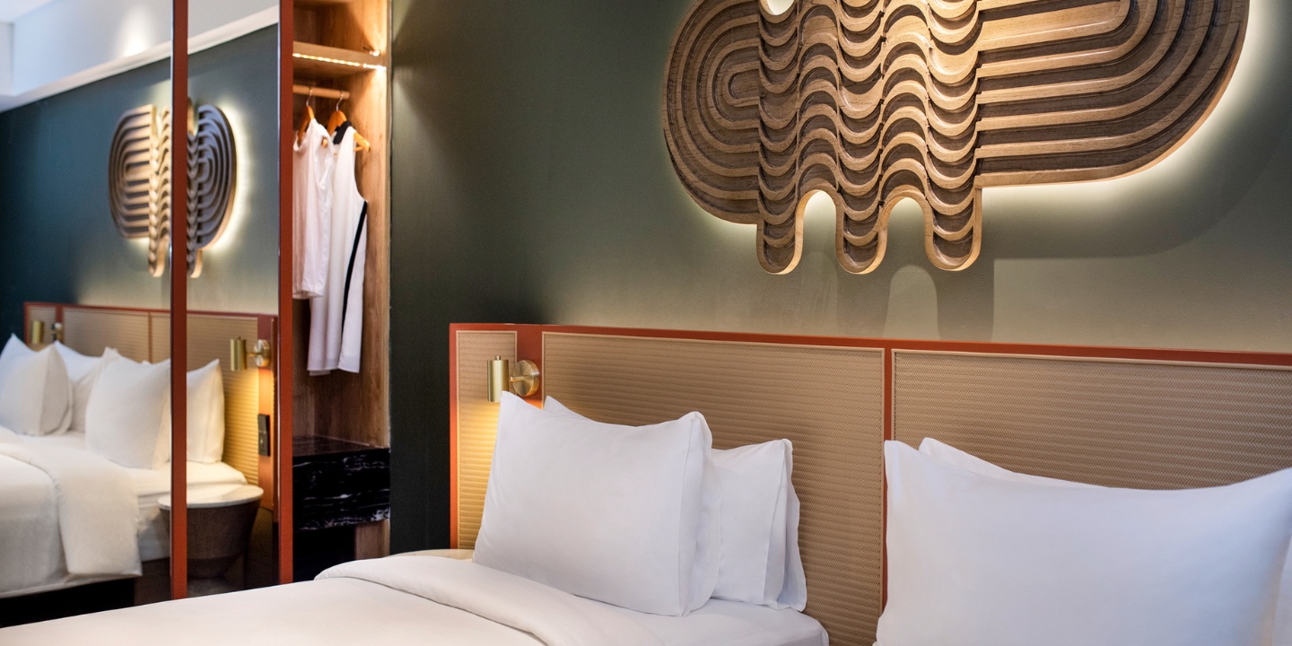 A guest rooms with twin beds and a wardrobe with a mirror