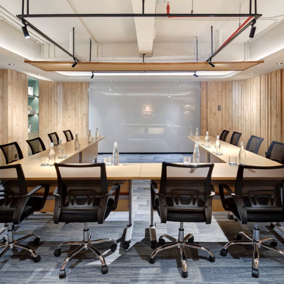 a meeting room set up in classroom style with 12 chairs
