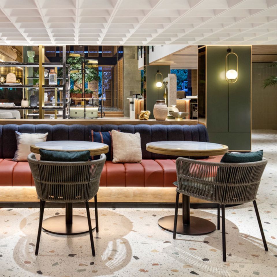 Blue and red couches and chairs around tables