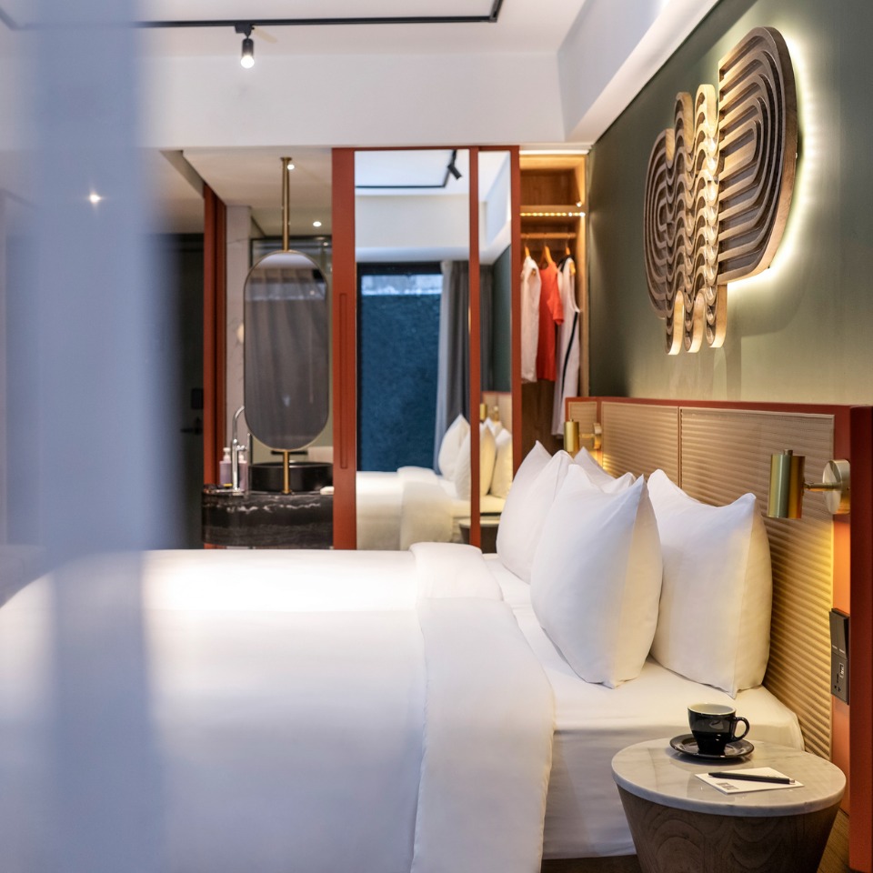 A guest room a double bed and a wardrobe with a mirror