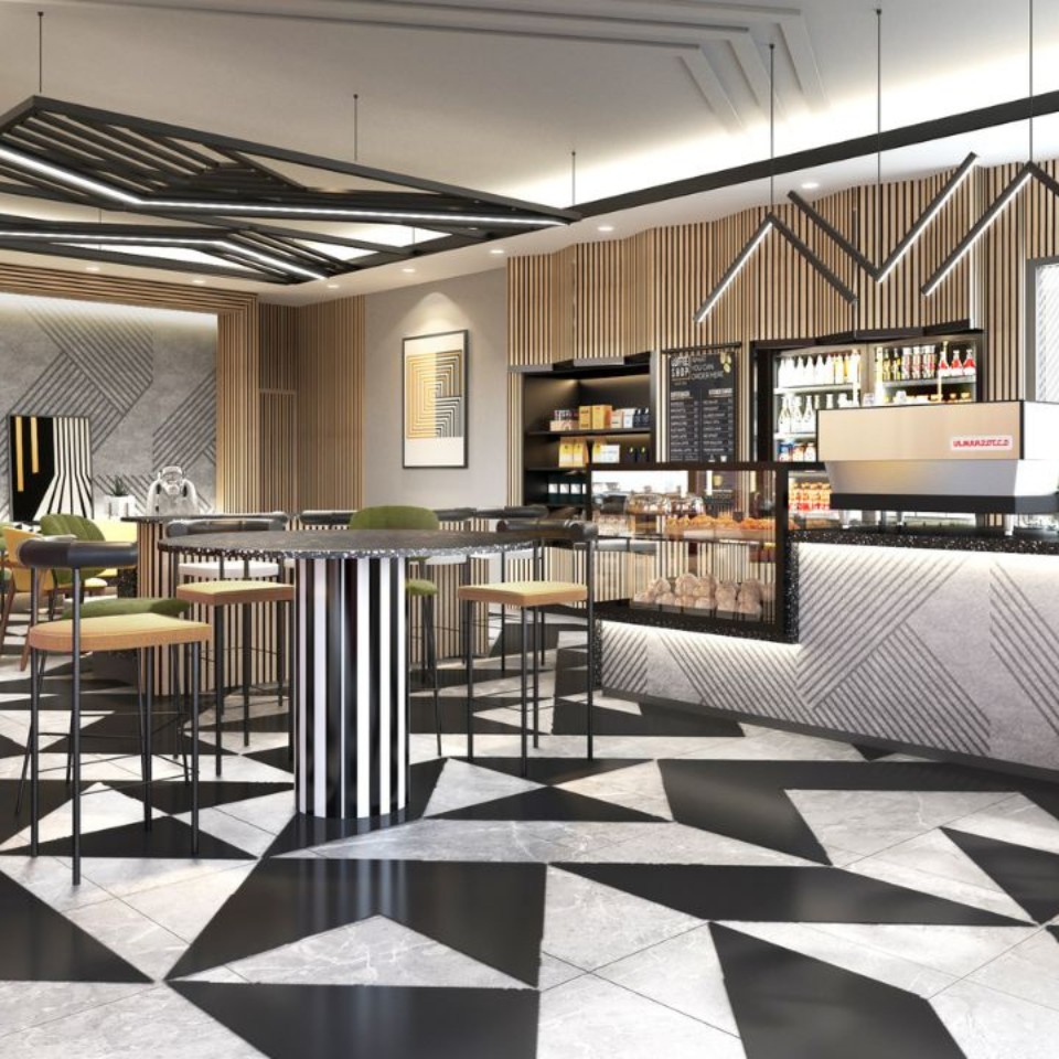 A stylish modern bar featuring geometric tiled flooring, sleek furnishings, and a well-stocked shelf with drinks and snacks.