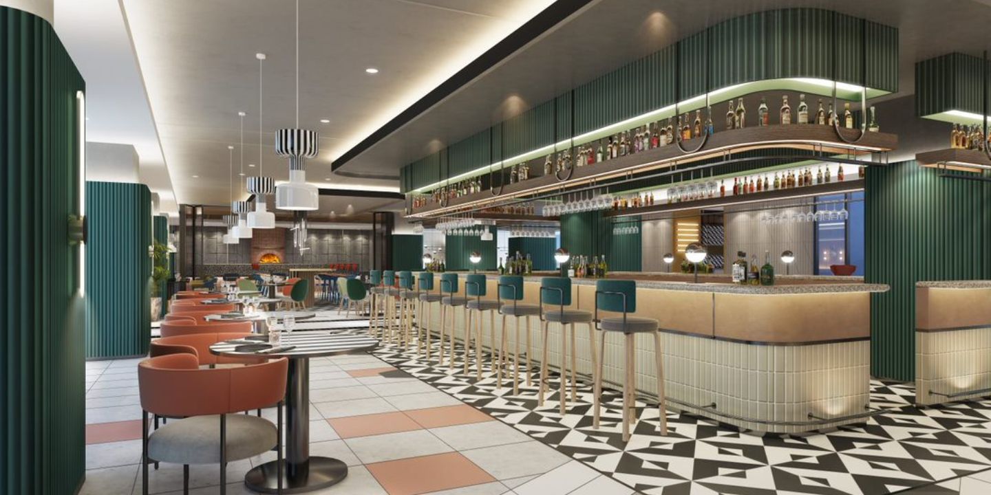 A modern bar interior featuring a stylish counter, high stools, and a vibrant display of liquor bottles on the shelves above.