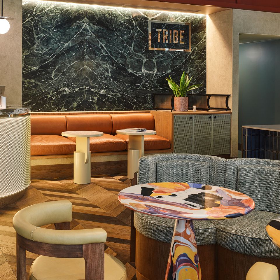 A common area at the hotel with several couches, chairs and tables