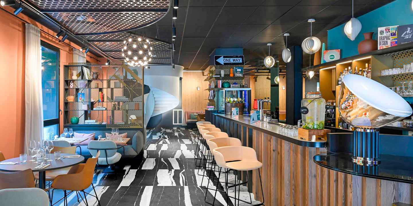 Full width image of colour eating area with set tables and bar