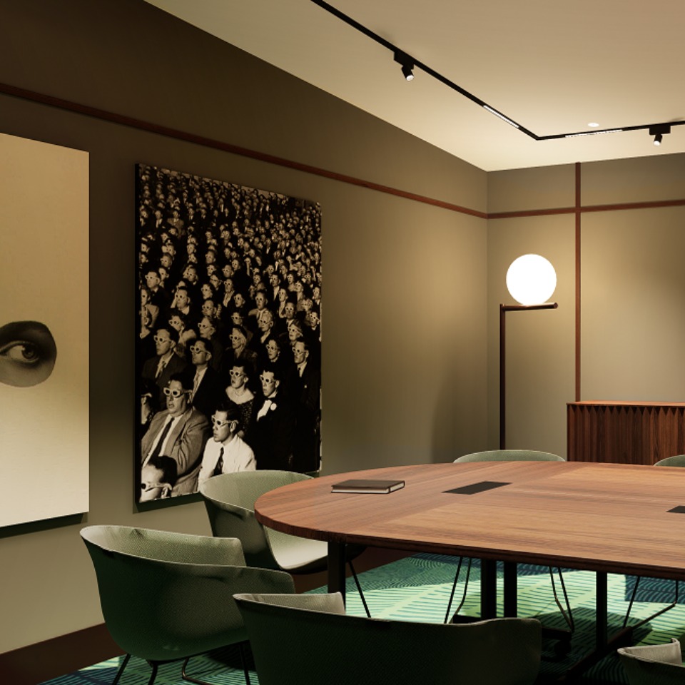 A meetingroom with a large wooden table in the middle. The colour scheme is defined by earth tones and there are black-and-white artworks on the wall.
