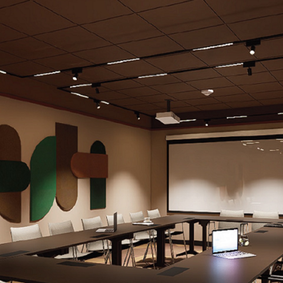 Meeting room in boardroom set up with abstract art on the wall and a whiteboard.