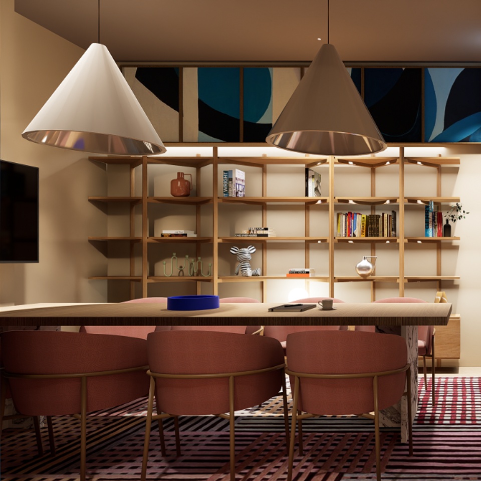 A large table in a hotel lobby, with several chairs around it. The wall are lined with shelves.