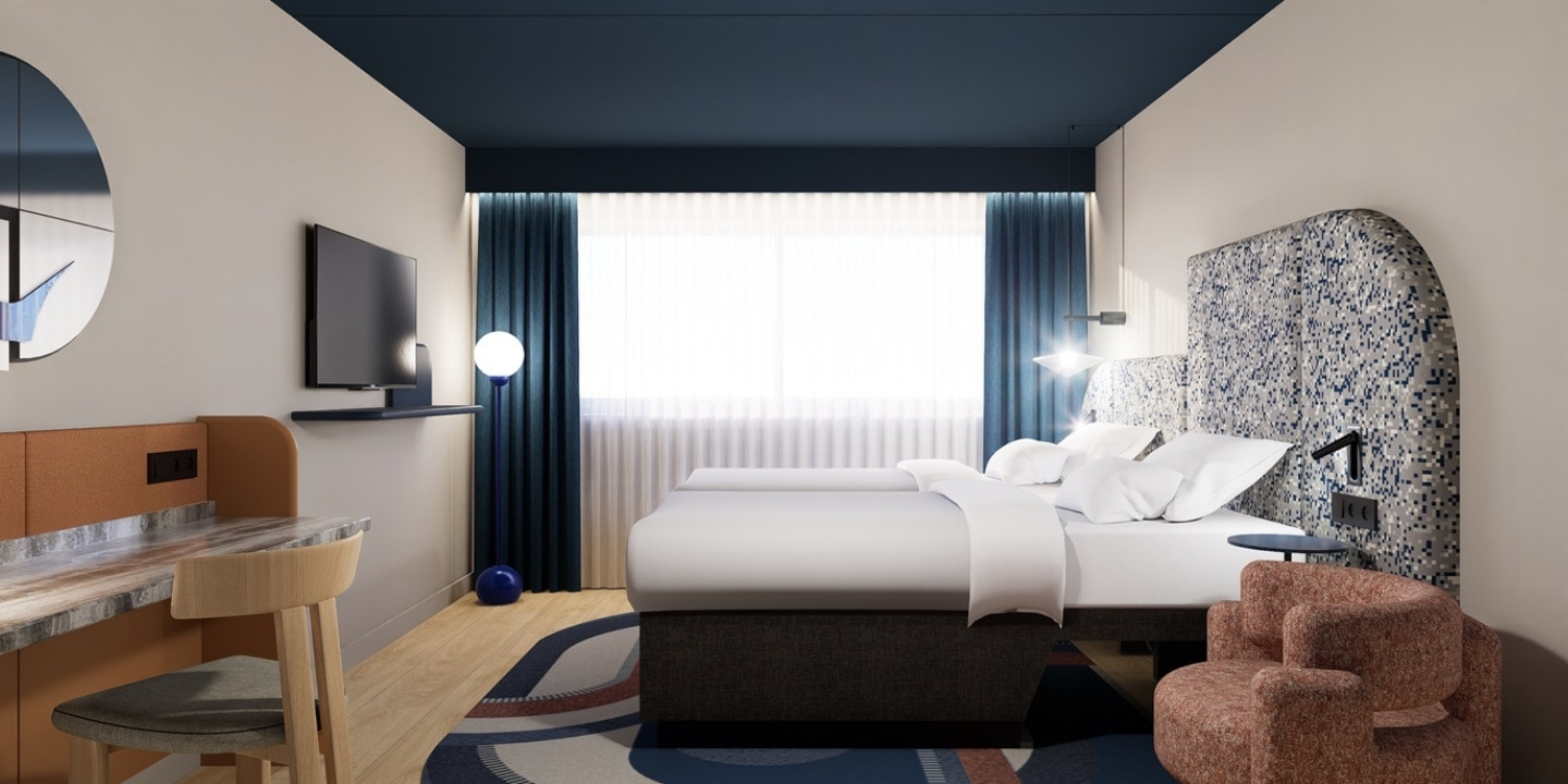 A hotel room featuring twin beds, a desk, a cozy chair, and a large window with sheer curtains, all in a contemporary style.