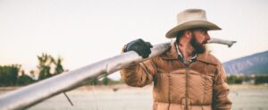cowboy with pipe on his shoulder