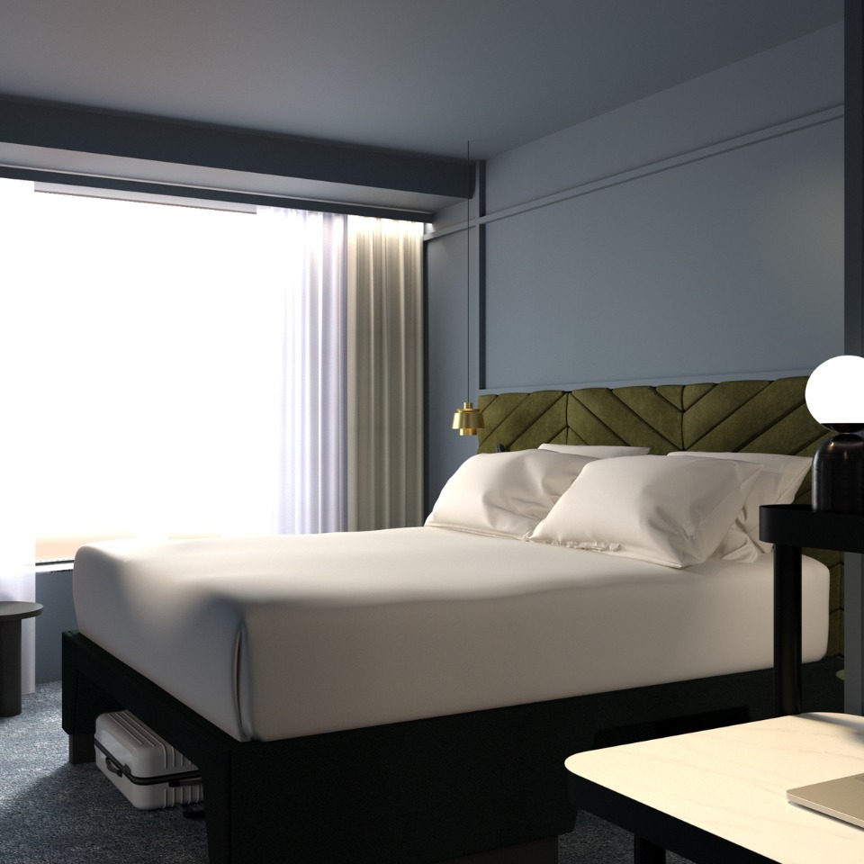 Cozy hotel room featuring a double beds, a green headboard, modern lamp, and sheer curtains letting in natural light.