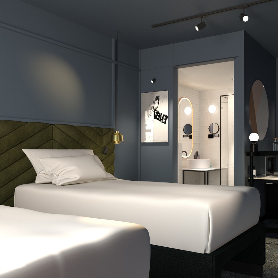 Modern hotel room featuring a plush bed, stylish artwork, and a glimpse of the sleek bathroom with a circular mirror.