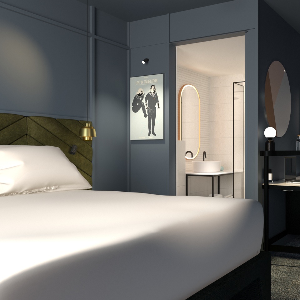 Modern hotel room featuring a plush bed, stylish artwork, and a glimpse of the sleek bathroom with a circular mirror.