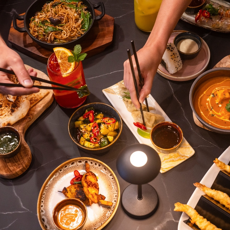 A dining table adorned with an assortment of food items and beverages, ready for a meal or celebration.