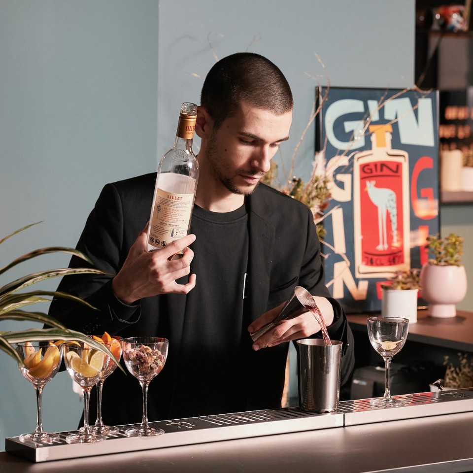 A barkeeper mixing a drink with Lillet at the Byron Bar