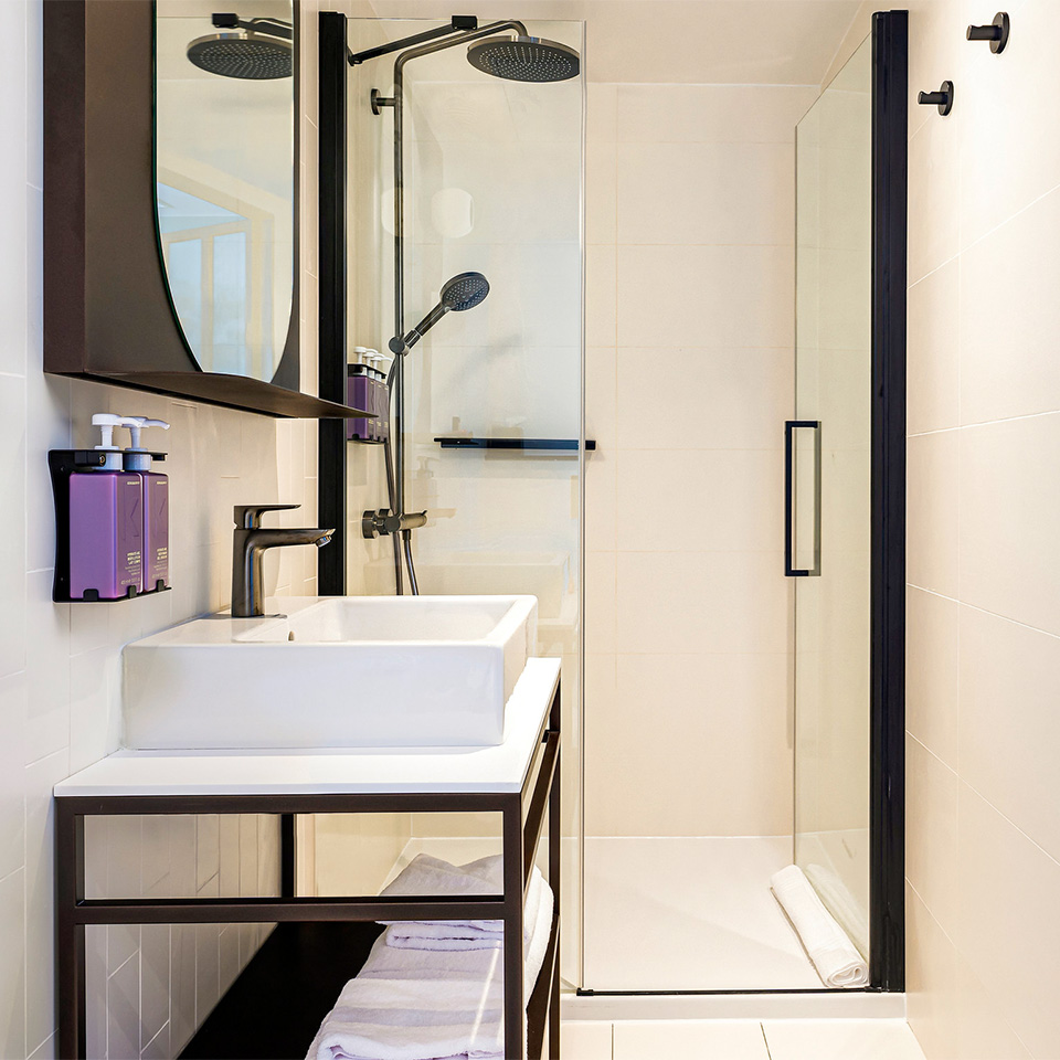 White bathroom with rain shower and make-up mirror