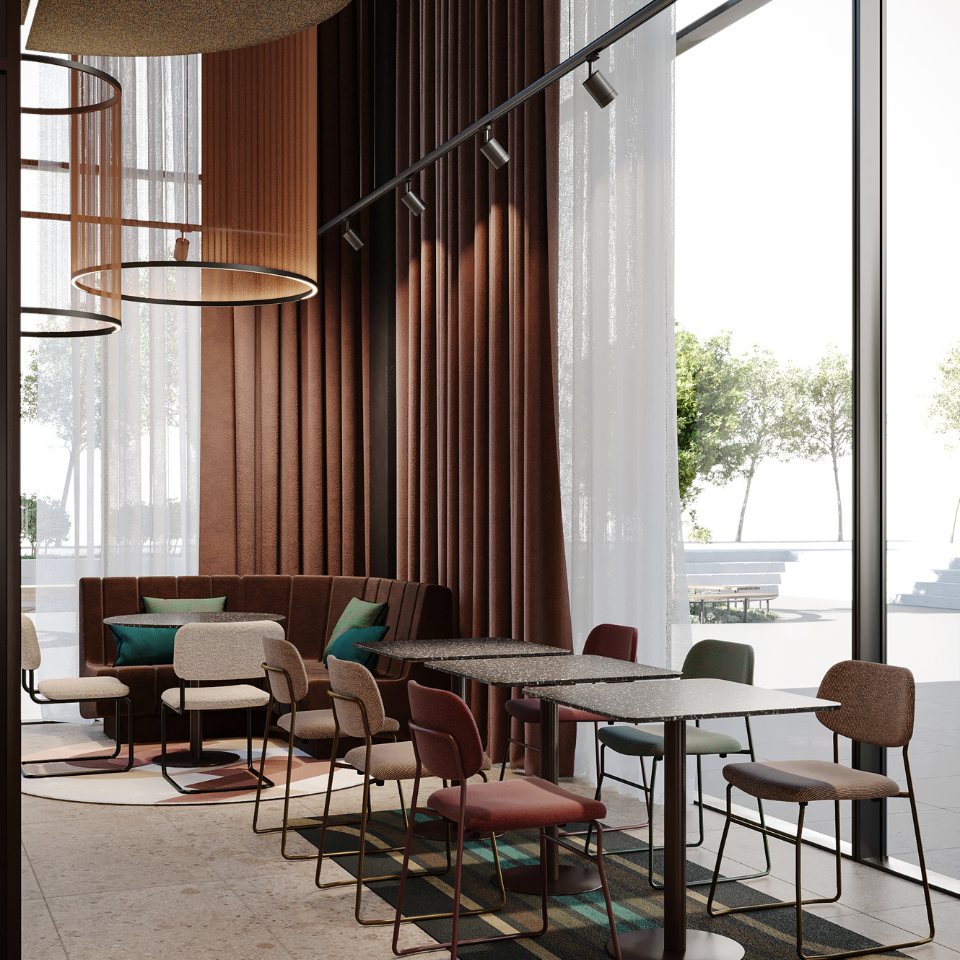 Modern café interior featuring a cozy seating area with rich textiles, colorful chairs, and large windows inviting natural light.