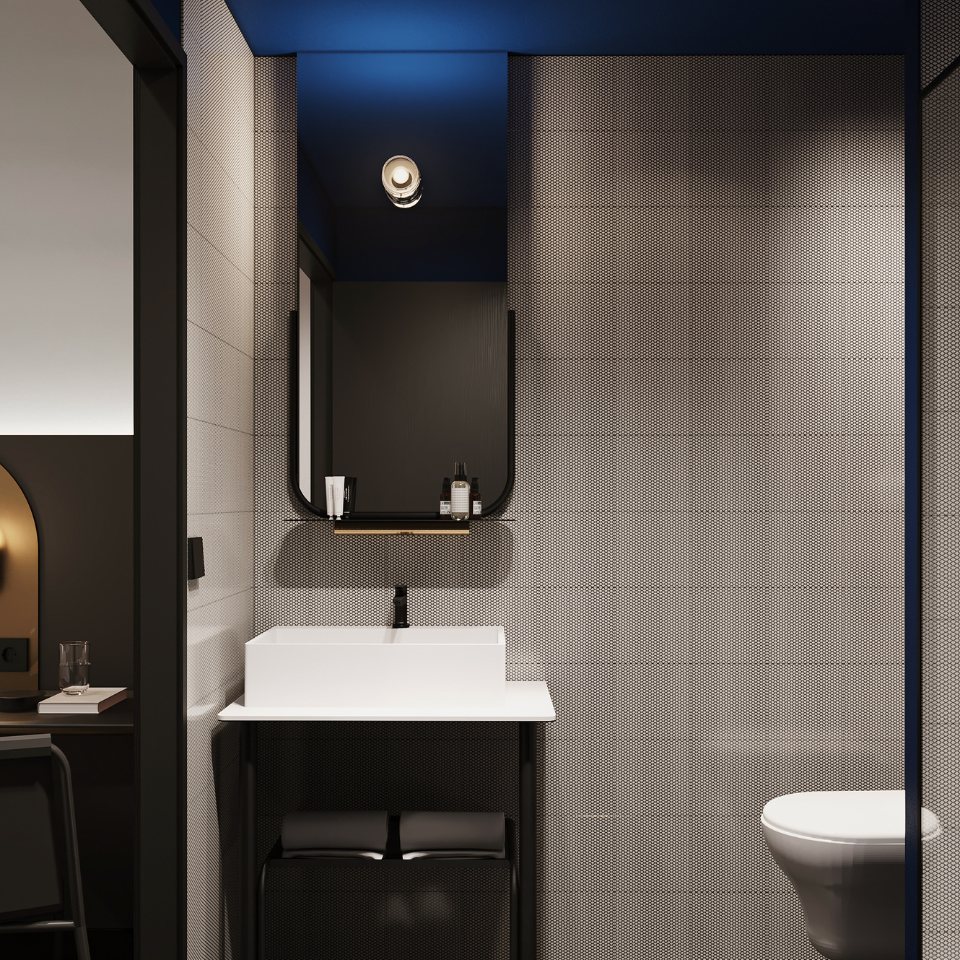 Modern bathroom featuring a sleek white sink, stylish mirror, and black accents against textured gray walls, illuminated by blue ceiling light.