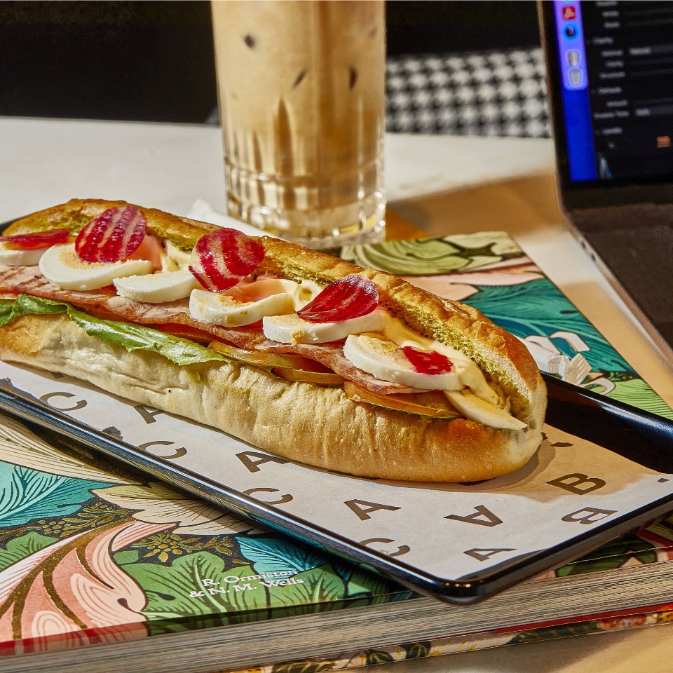 A sandwich with various fillings, such as egg and salad