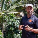 man in blue shirt and baseball cap