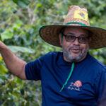 man in blue shirt with hat